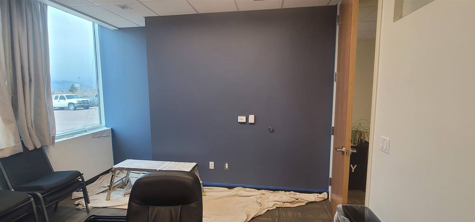 Office interior with navy blue accent wall
