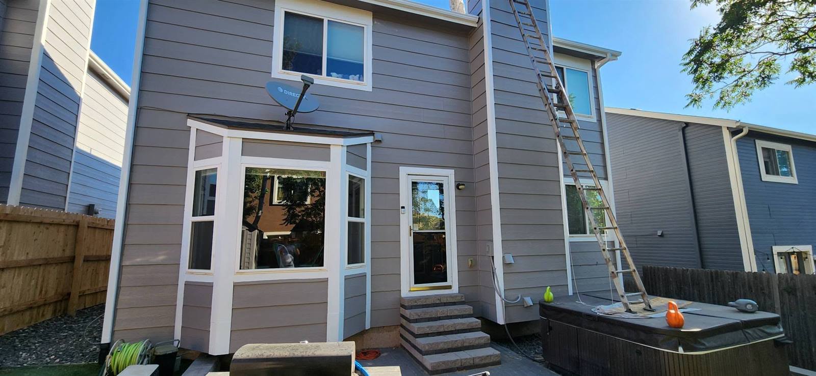 Close-up of exterior siding repaint in progress