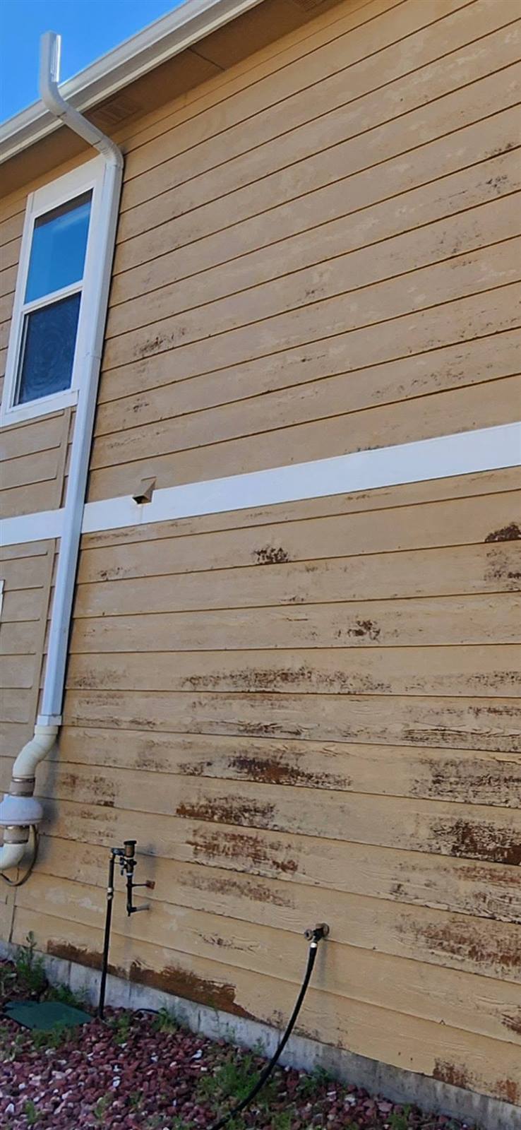 Close-up of weathered exterior siding before repaint
