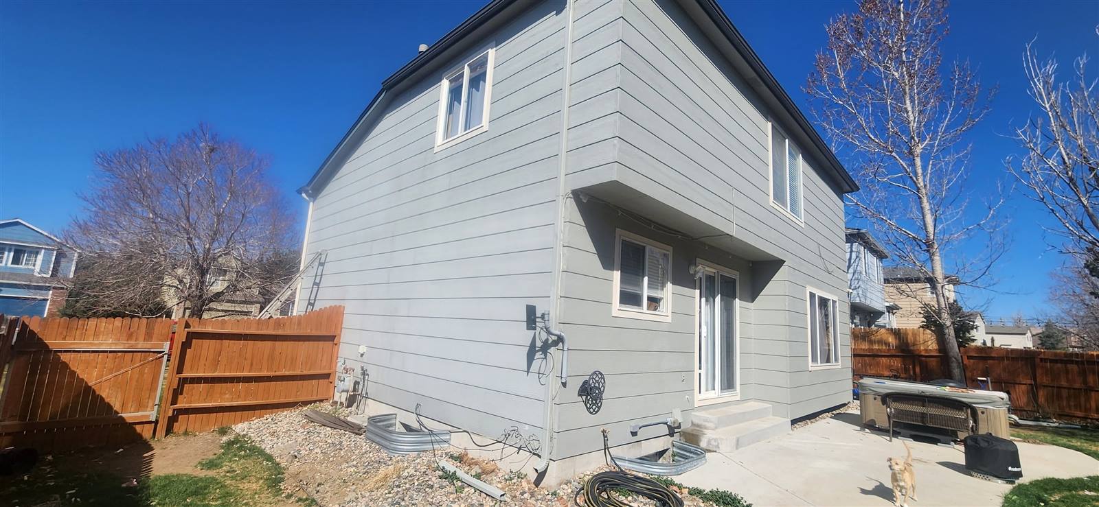 Finished two-story exterior repaint with fenced yard