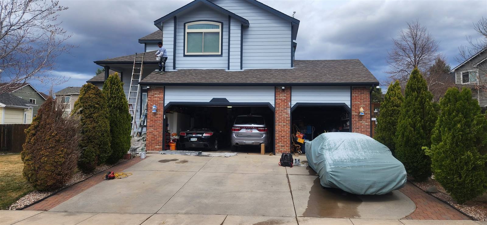 Finished exterior repaint with brick and siding