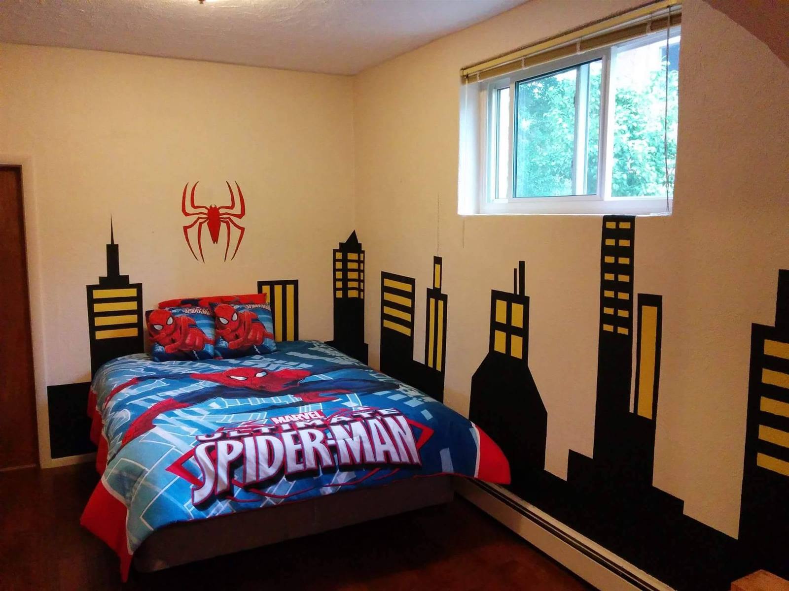 Kids bedroom with Spider-Man themed wall mural