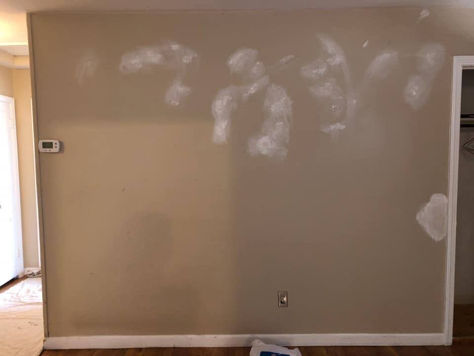 Wall patched and sanded ahead of a small room repaint