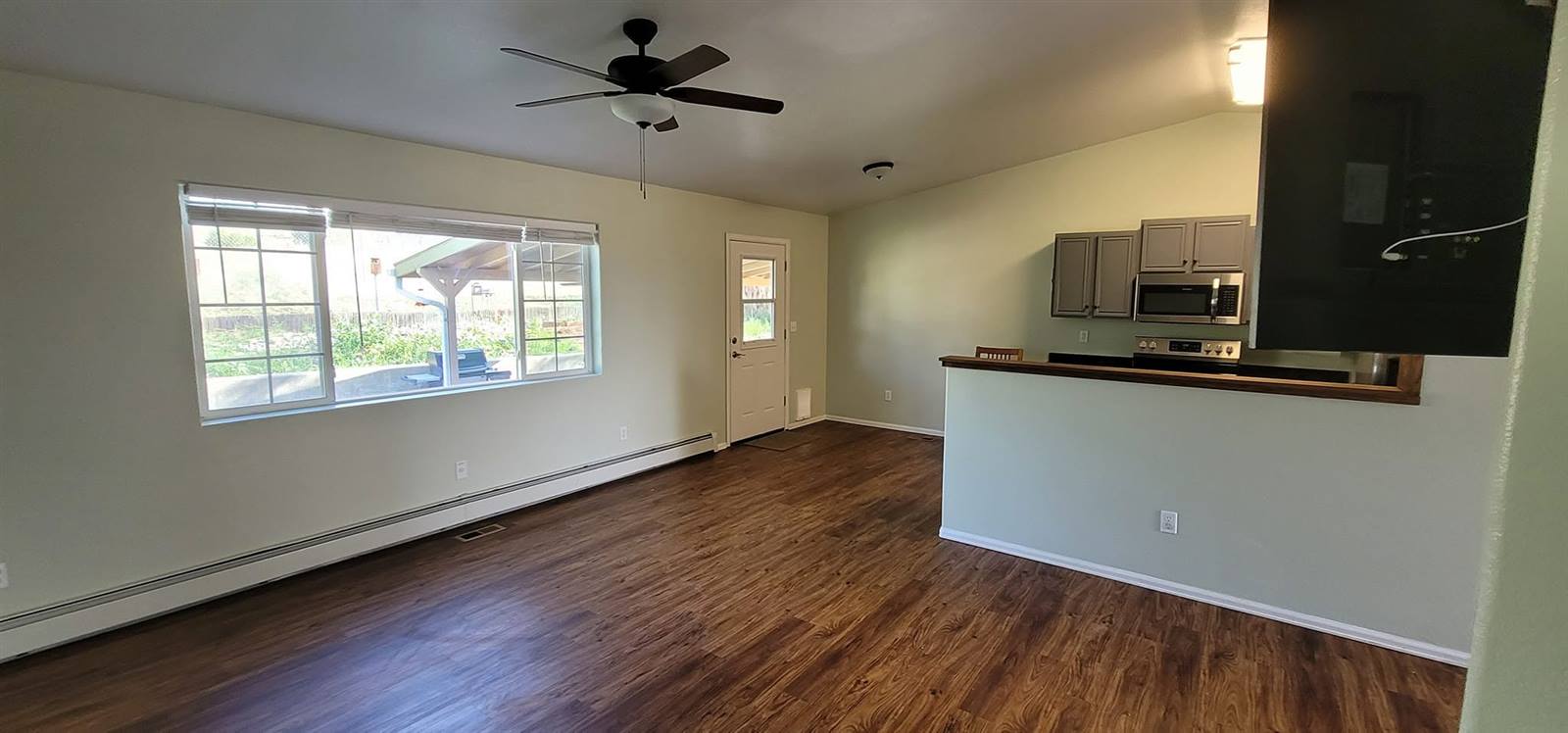 Open-concept kitchen and living room, freshly painted