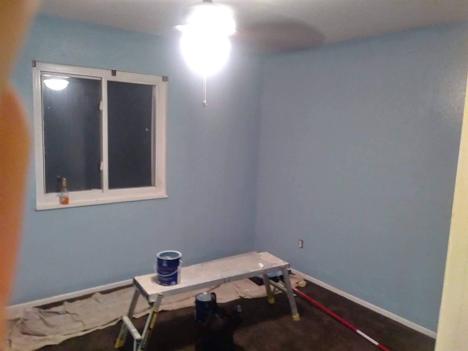 Interior room mid-prep with patched walls before repaint